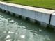 A sturdy concrete seawall rises from the tranquil waters, reinforced by visible supports at 525 Crystal Dr, Madeira Beach, FL 33708