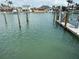 Picturesque waterfront scene with docks, boats, and waterfront homes under a bright sky at 525 Crystal Dr, Madeira Beach, FL 33708