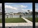 Waterfront view featuring an outdoor patio overlooking lush lawn and a canal with docks and boats at 525 Crystal Dr, Madeira Beach, FL 33708