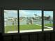 Waterfront view featuring a canal with docks and boats, as seen through a multi-pane window at 525 Crystal Dr, Madeira Beach, FL 33708