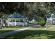 A cozy gazebo, perfect for relaxing, is surrounded by lush greenery and walking paths at 5335 Powhattan St, Zephyrhills, FL 33542