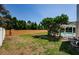Large backyard with plenty of grass area with a beautiful fence view near the screened pool at 5342 Sagamore Ct, New Port Richey, FL 34655