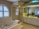 Luxurious bathroom with a jetted tub, glass-enclosed shower, and double vanity sinks for ultimate relaxation at 5342 Sagamore Ct, New Port Richey, FL 34655