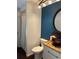 Stylish bathroom featuring a wainscoted wall, a dark blue accent wall, and a vessel sink on a granite countertop at 5342 Sagamore Ct, New Port Richey, FL 34655