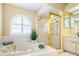 Beautiful bathroom with a luxurious tub and a glass enclosed shower at 5342 Sagamore Ct, New Port Richey, FL 34655