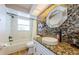 Updated bathroom with a large window above the tub and modern sink at 5342 Sagamore Ct, New Port Richey, FL 34655