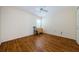 A simple, bright bedroom featuring hardwood floors and a ceiling fan at 5342 Sagamore Ct, New Port Richey, FL 34655