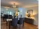 Elegant dining room with a mirrored wall, a chandelier, and a sideboard with decorative lamps at 5342 Sagamore Ct, New Port Richey, FL 34655