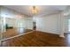 Open dining room featuring mirrored wall and hardwood floors at 5342 Sagamore Ct, New Port Richey, FL 34655