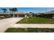 Well manicured lawn with sidewalks leading to the front door and a two car garage at 5342 Sagamore Ct, New Port Richey, FL 34655
