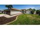 A well-manicured lawn with sidewalks leading to the front door and a two car garage at 5342 Sagamore Ct, New Port Richey, FL 34655
