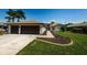 Well manicured lawn with sidewalks leading to the front door and two car garage at 5342 Sagamore Ct, New Port Richey, FL 34655
