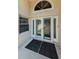 Elegant front door with decorative glass and transom window provides a welcoming entrance to the home at 5342 Sagamore Ct, New Port Richey, FL 34655