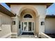 Grand entryway featuring arched detailing, double doors, and side windows for a bright and inviting welcome at 5342 Sagamore Ct, New Port Richey, FL 34655