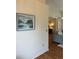 Hallway with decorative painting that leads to the living room. The house has laminated floors at 5342 Sagamore Ct, New Port Richey, FL 34655