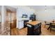Kitchen featuring a wooden floors and island, granite counters and white cabinets at 5342 Sagamore Ct, New Port Richey, FL 34655