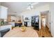 Well lit kitchen featuring dark appliances, a breakfast table, granite counters and white cabinets at 5342 Sagamore Ct, New Port Richey, FL 34655