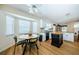 Kitchen with breakfast nook area, granite countertops, island, and white cabinets at 5342 Sagamore Ct, New Port Richey, FL 34655