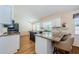 Spacious kitchen with white cabinetry, granite countertops, black appliances, and a central island at 5342 Sagamore Ct, New Port Richey, FL 34655