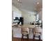 Open kitchen with bar seating, granite countertops, stainless steel appliances, and a view to dining area at 5342 Sagamore Ct, New Port Richey, FL 34655