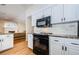 Updated kitchen features black appliances, granite countertops, and white cabinets at 5342 Sagamore Ct, New Port Richey, FL 34655