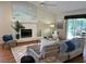 Open living room with fireplace, stylish furnishings, and sliding glass doors to the pool area at 5342 Sagamore Ct, New Port Richey, FL 34655