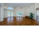 Bright and airy living room with wood floors, high ceilings, a ceiling fan, and French doors to the pool at 5342 Sagamore Ct, New Port Richey, FL 34655