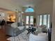 Bright and airy living room with vaulted ceilings, a ceiling fan, and views of the pool area at 5342 Sagamore Ct, New Port Richey, FL 34655