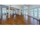 Expansive living room showcasing beautiful wood floors, high ceilings and multiple French doors leading to the outdoors at 5342 Sagamore Ct, New Port Richey, FL 34655