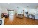 Open concept living area with wood floors, modern lighting, and access to the kitchen and patio at 5342 Sagamore Ct, New Port Richey, FL 34655