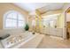 This main bathroom is well-lit and features a large tub, walk-in shower, and an extended double vanity at 5342 Sagamore Ct, New Port Richey, FL 34655