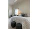 This main bedroom has light walls and carpet and features a comfortable bed with a reading nook next to a window at 5342 Sagamore Ct, New Port Richey, FL 34655