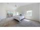 Bright primary bedroom with vaulted ceiling, plush carpet, and sliding glass doors to the outside at 5342 Sagamore Ct, New Port Richey, FL 34655