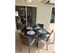 Cozy outdoor dining space with seating for four, ideal for enjoying meals on the screened lanai at 5342 Sagamore Ct, New Port Richey, FL 34655