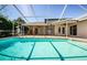 Sparkling screened pool area with covered patio, surrounded by lush landscaping, creating a private oasis at 5342 Sagamore Ct, New Port Richey, FL 34655