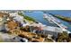 Condo building exterior showing stairs, palm trees, and nearby marina at 5850 Gasparilla Rd # M5, Boca Grande, FL 33921