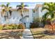 Condominium exterior with mature landscaping, offering a tranquil entrance to this coastal residence at 5850 Gasparilla Rd # M5, Boca Grande, FL 33921