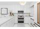 Modern kitchen with stainless steel appliances, white cabinets, and stylish fixtures for a contemporary feel at 5850 Gasparilla Rd # M5, Boca Grande, FL 33921