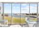 Screened lanai with water views, ample seating, and bright natural light at 5850 Gasparilla Rd # M5, Boca Grande, FL 33921