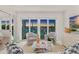 Stylish living room with view of harbor and boats at 5850 Gasparilla Rd # M5, Boca Grande, FL 33921