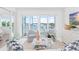Bright living room with waterfront views, patio access and stylish decor at 5850 Gasparilla Rd # M5, Boca Grande, FL 33921