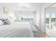 Light and airy main bedroom featuring waterfront views and soft decor at 5850 Gasparilla Rd # M5, Boca Grande, FL 33921