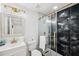 Bathroom with a marble counter, brushed gold hardware, and a glass shower door at 602 Highview S Ter, Brandon, FL 33510