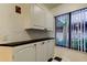 Convenient butler's pantry with storage cabinets and a black countertop, perfect for entertaining at 6269 Palma Del Mar S Blvd # 111, St Petersburg, FL 33715