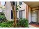 Exterior of unit 111 with lush landscaping, a secure front door, and designated parking at 6269 Palma Del Mar S Blvd # 111, St Petersburg, FL 33715