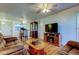 Open-concept living area with hardwood floors, an entertainment center and comfortable seating at 6269 Palma Del Mar S Blvd # 111, St Petersburg, FL 33715