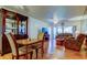 Open-concept living area with hardwood floors, an entertainment center, and a dining room with a china cabinet at 6269 Palma Del Mar S Blvd # 111, St Petersburg, FL 33715