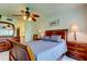Cozy main bedroom with wood furniture, ceiling fan, and ensuite bathroom at 6269 Palma Del Mar S Blvd # 111, St Petersburg, FL 33715