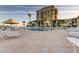 Relaxing community pool area with lounge chairs, umbrellas, and well-maintained brick pavers at 6269 Palma Del Mar S Blvd # 111, St Petersburg, FL 33715