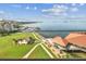Scenic aerial view of the property with the gazebo, green space, and a long pier on the waterfront at 634 Edgewater Dr # 744, Dunedin, FL 34698